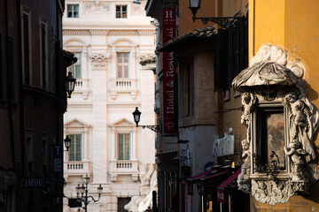 Narrow Italian street in Rome. Light and shadow, art and stone with historical architecture details