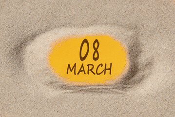 March 8. 8th day of the month, calendar date. Hole in sand. Yellow background is visible through hole. Spring month, day of the year concept