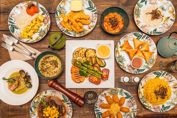 Mediterranean food dishes, oriental rice dishes and Spanish stews. Grilled vegetables and wild berries, hake in green sauce, croquettes, vegetable samosas