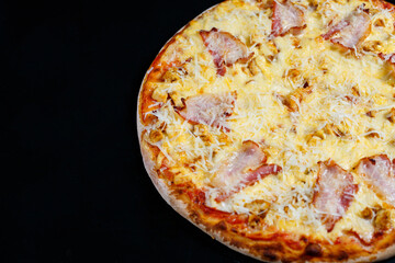 Chicken breasts with creamy sauce and grated cheese on a pizza. tasty fresh pizza on a thick crust with meat