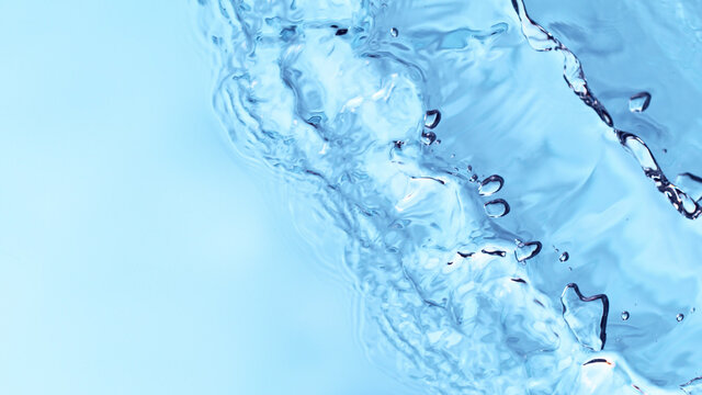 Abstract image of top view of shiny wave of clear blue water.