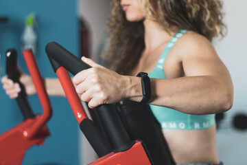 a young girl with curly hair doing cardio indoors in a gym