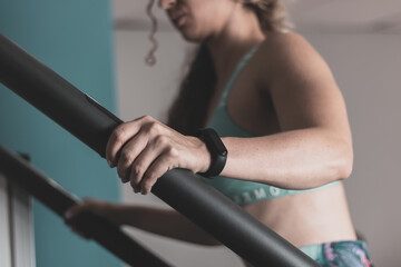 a young girl with curly hair doing cardio indoors in a gym