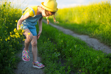 Girl kills mosquitoes on her hands and feet. Child slaps himself on body, scratches places of...
