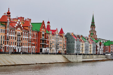 A view of the Dutch-style Embankment of Bruges from the other side of the river. Russia Yoshkar-Ola 01.05.2021. High quality photo