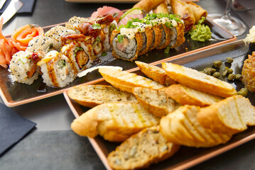 sushi set with fried baguette close-up. eating sushi at sushi restaurant.