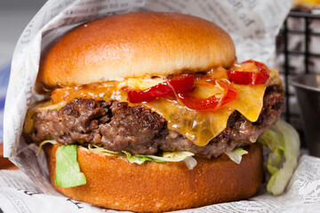 Classical hamburger with baked meat served on wooden board