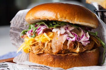 Classical hamburger with baked meat served on wooden board