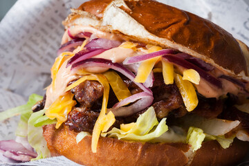 Classical hamburger with baked meat served on wooden board