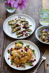 Vegan dishes of miso aubergine, roasted cauliflower and baby courgettes