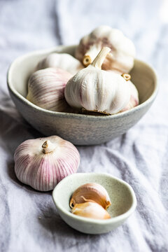 Fresh cloves of garlic and garlic bulbs on a table