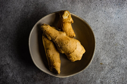 Overhead view of a bowl of fresh ginger roots