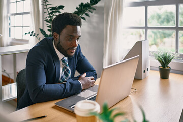 Young black man working inside modern office - Focus on face