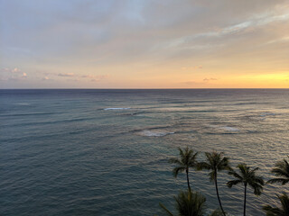 Aerial of Dusk on the oeacn with waves rolling in off Waikiki