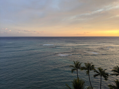 Aerial of Dusk on the oeacn with waves rolling in off Waikiki © Eric BVD