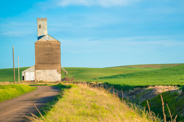 View of industrial grain elevator seen from wheat farm in the Palouse Washington state