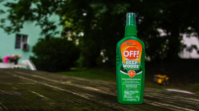  Off! deep woods insect repelent on table outside with green  background