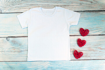 Blank white t-shirt with heart decor, unisex valentine's day apparel mock up. Stock photo.