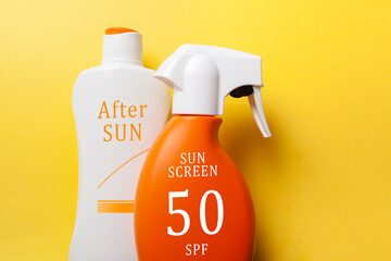 Sun screen and after sun lotion set on yellow background. summer care concept.