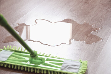 wet floor and mop wiping water, closeup