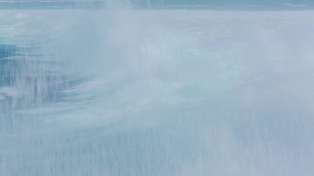 Close-up of a huge wave rolling quickly on the sea surface of Saipan