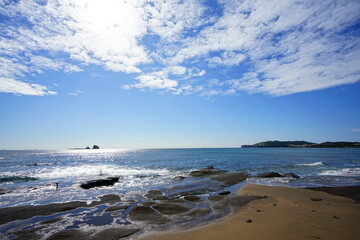 a beautiful seascape with an island and clouds