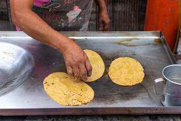 woman's hand preparing a typical mexican food as a quesadillas, sopes, huaraches and more
