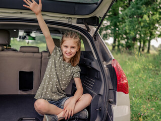 Preteen girl with car at the nature