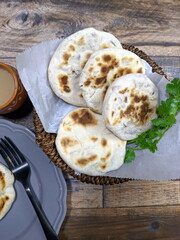 A close up of a basket of Baati roti for breakfast.