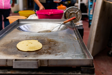 tortilla cooking on a grill to do tacos and other mexican food