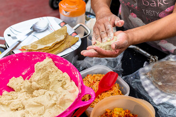 woman's hands preparing dough to do typical mexican dishes