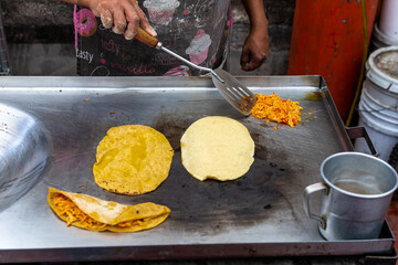 woman's hand preparing a typical mexican food as a quesadillas, sopes, huaraches and more