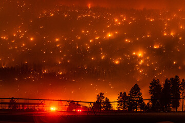 California mountain glows from Tennant Fire in western USA with pivot line and fire truck