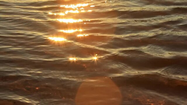 Top view of the sun shining on the rippling sea