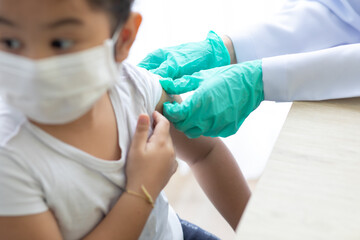 Asian little girl getting dengue vaccine. Pediatrician. pediatric checkup in hospital children...