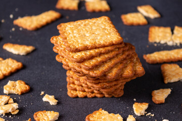 Salty cracker on a dark table.