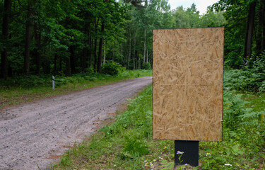 Particle board empty template of an outdoor info banner. A mockup of an information poster in a...