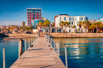 Stunning spring cityscape of Vlore port with old wooden pier. Calm morning seascape of Adriatic sea. Bright outdoor scene of Albania, Europe. Traveling concept background.
