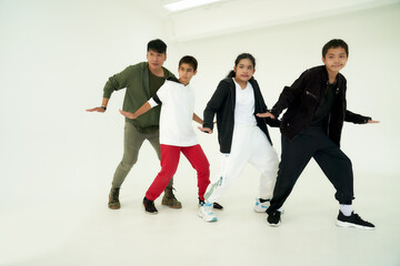 Dancing childen class concept , with boys and girld trained with trainer in white studio room