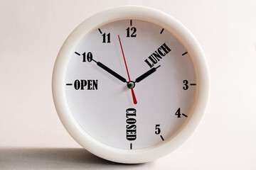 Sign design for a shop or office, opening and closing times in the form of a wall clock.