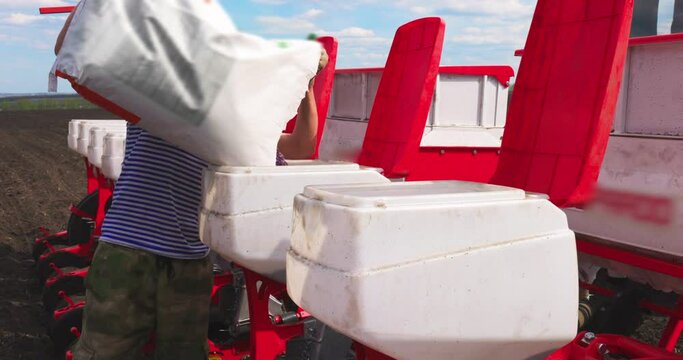 Farmer Fills up Sunflower Seeds Tractor Seeding Machine Field Seeder Rural Working Combine Tillage Agricultural Equipment Season Sowing Grain Spring time Process Planting Slow motion Agriculture Farm