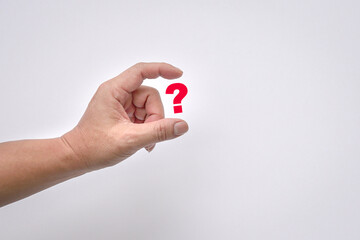 Man's fingers virtually hold a red question mark on white background. Copy space.