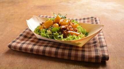 asian hakka traditional cuisine snack menu stir fried abacus ball with minced meat and mushroom in small paper bowl on wood table (suan pan zi)