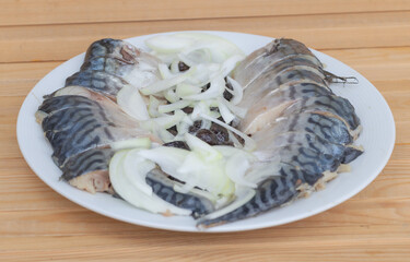 Closeup shot of marinated fish and onion on a white plate