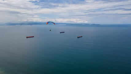 Beautiful aerial view of the extreme sport of paragliding on the Beach and mountains of Costa Rica 