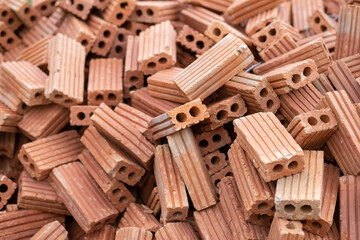 selective focus orange brick blocks piled on the floor orange bricks used to build houses and buildings used to build walls
