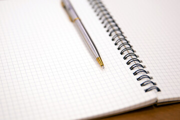 Close-up notebook or note book diary with a pen or pencil on top view desk or boardroom table for meeting notes.