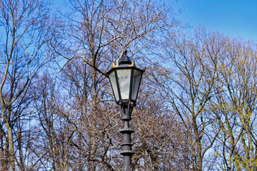 Vintage gas street lamp on a background of blue sky - 443023010