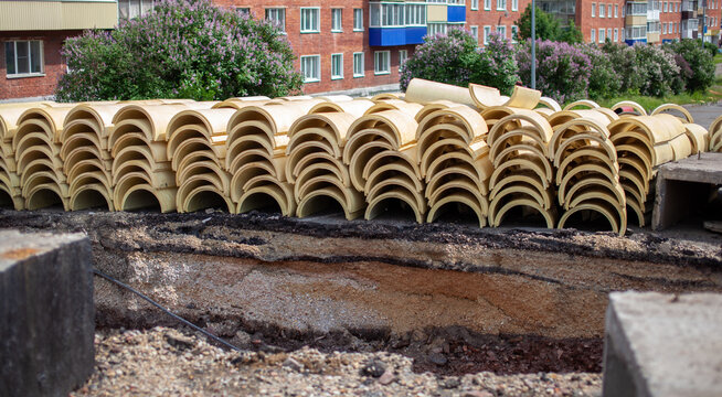 Round insulation for thermal insulation of heating pipes. Repair work in the city, the road is dug up, the insulation is on the surface, replacement of pipes, preparation for the heating season.