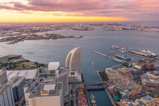 Yokohama, Japan - YOKOHAMA city MINATOMIRAI, Panorama twilight cityscape and colorful golden light skyline of Yokohama from the Yokohama bay during sunset from the observation tower of Landmark Tower.